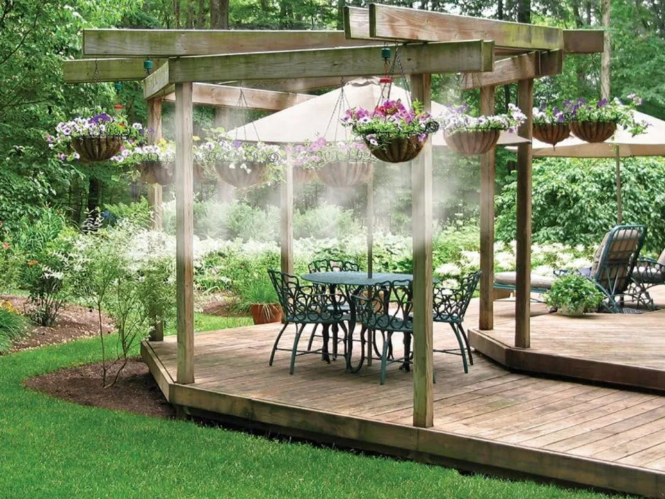 Patio misting system cooling an outdoor seating area