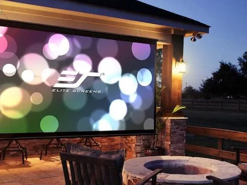 Bright outdoor projector screen on a patio at dusk